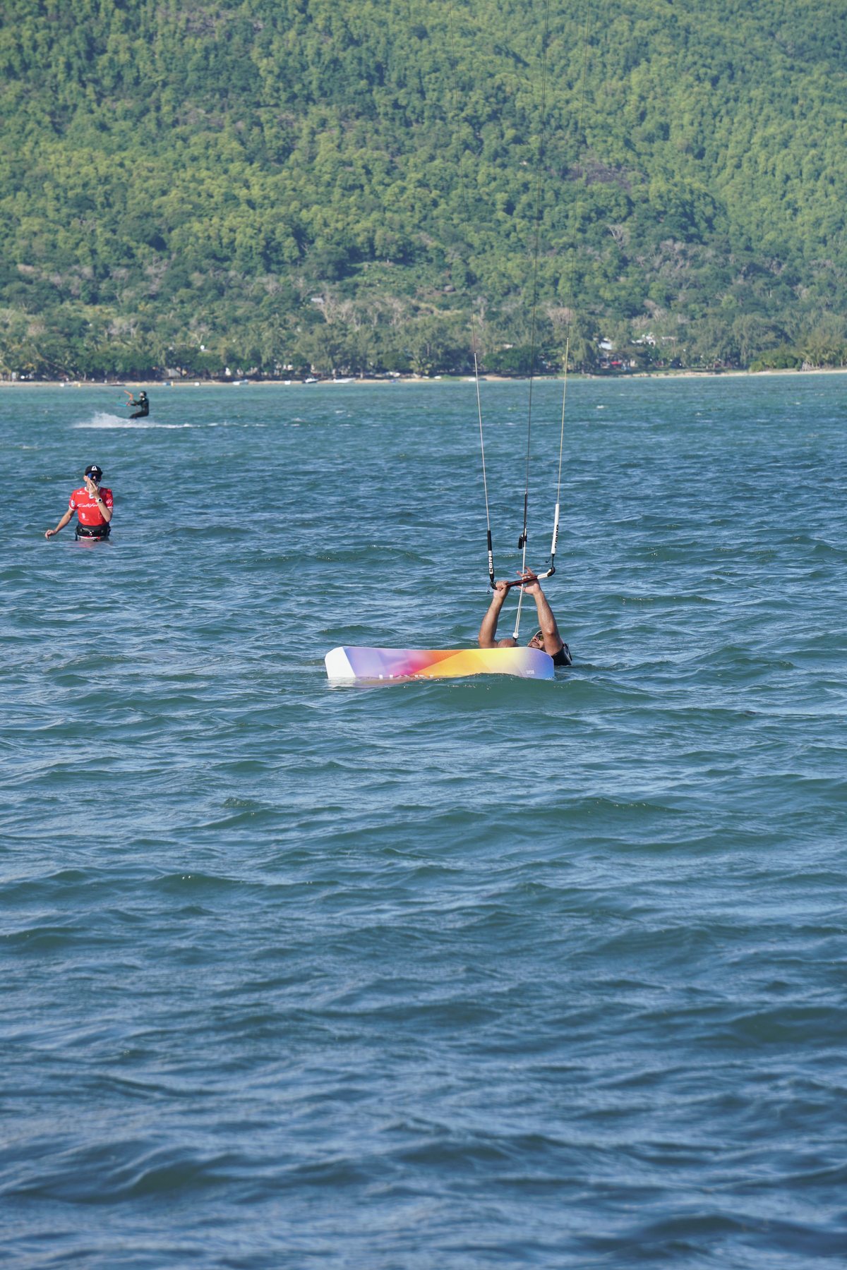 Instructor relaunching a kite with a student in the water